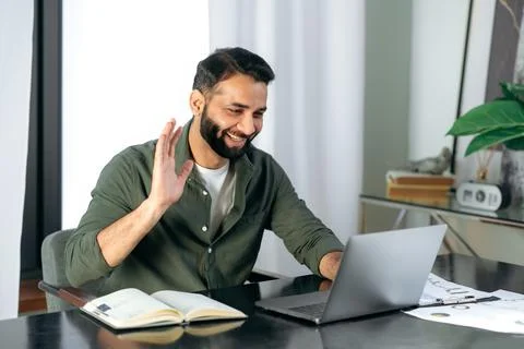 Pleasant friendly indian guy, manager or financial consultant, communicates with Stock-Fotos