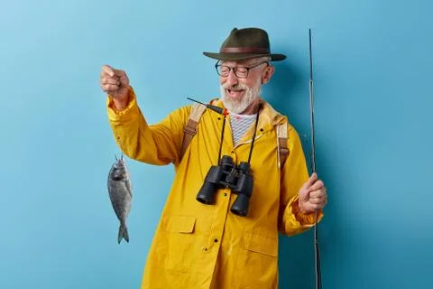 Pleasant good looking fishman gets pleasure from fishing Stock Photos