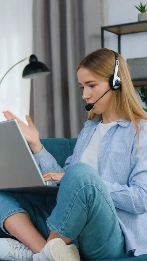 Pleasant in good mood purposeful young blondie in headphones sitting in relaxed  Stock Footage 331438041