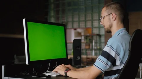 Pleasant-looking Slavic young man with beard sitting at table and working Stock Footage 93163744