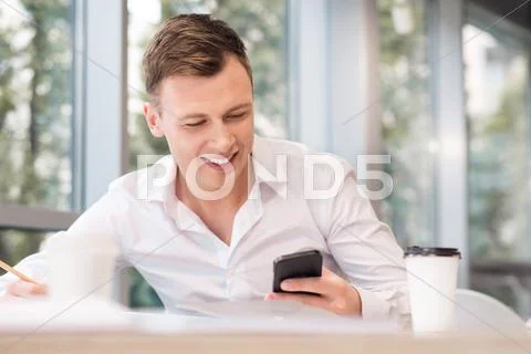 Pleasant Man Holding Cell Phone