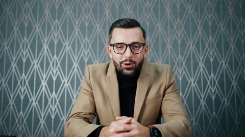 Pleasant man talking and looking at the camera. Glad Boss in the classical Stock Footage 267822387