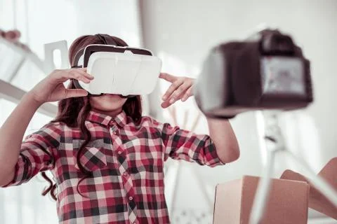 Pleasant smart girl using virtual reality glasses Stock Photos