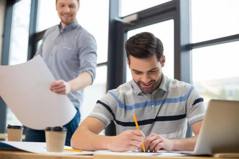 Pleasant smart man doing a drawing Stock Photos
