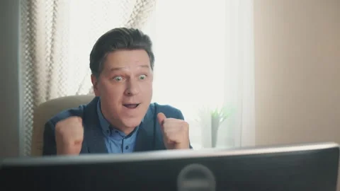 Pleasant surprise of a man at a computer Stock Footage 169647383