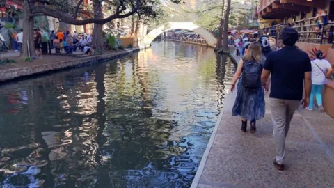 Pleasant, tranquil spring scene, San Antonio Riverwalk, arch bridge in distance Vídeo Stock 277860302