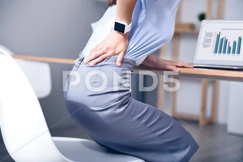 Pleasant woman feeling pain in her back Stock Photos