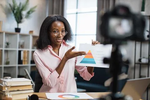 Pleasant woman using digital camera for remote work Stock Photos