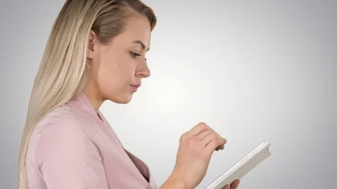 Pleasant woman using tablet on gradient background. Stock Footage 104134671