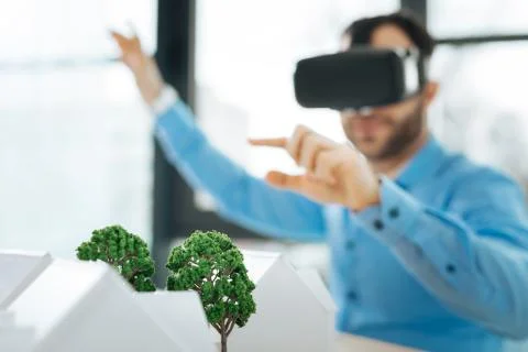 Pleasant young architect working in a VR headset Stock Photos