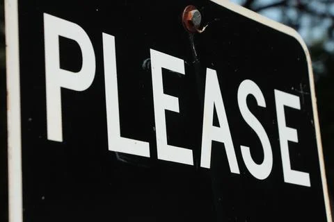 Please caption writing word text sign in white capital letters on black Foto stock