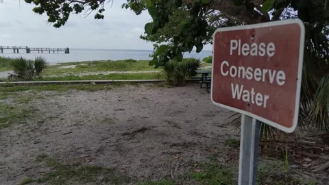 Please conserve water sign by empty beach due to red tide in Florida 動画素材 158842748