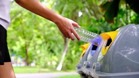 Please dispose of plastic bottle into the tank. A man throw rubbish in the trash Stock Footage 231975817