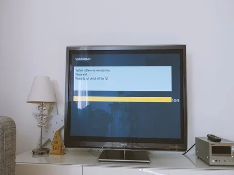 Please do not switch off your tv tv update Panasonic TV update in living room Stock Footage 79405015