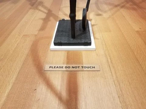 Please do not touch sign on floor near sculpture Stock Photos
