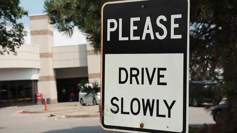 Please drive slowly caption writing text rectangle metal sign with person exit Stock Footage 247144150