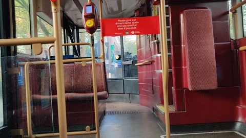 'PLEASE GIVE YOUR DRIVER SOME SPACE' SIGN ON EMPTY BUS COVID-19 LOCKDOWN, 4K Stock Footage 128835938