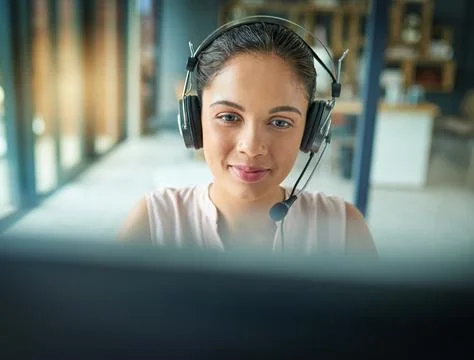 Please hold while I connect your call. Shot of a young woman working in a call Fotos Stock