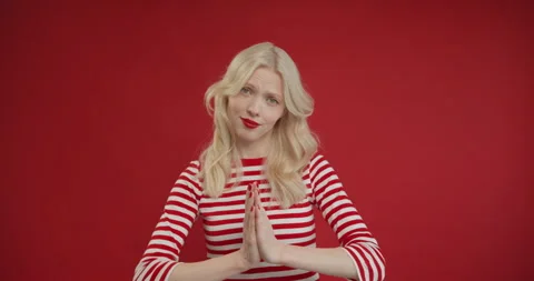 Please, I need. Cute beseeching blonde woman holding hands in prayer and Stock Footage 150907458