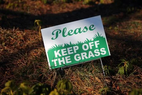 Please, Keep of the grass sign on a fall grass Stock Photos