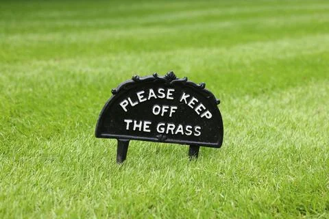 Please keep off the grass sign on lawn, UK park Stock Photos
