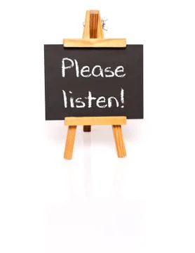 Please listen. Blackboard with text and easel. Stock Photos