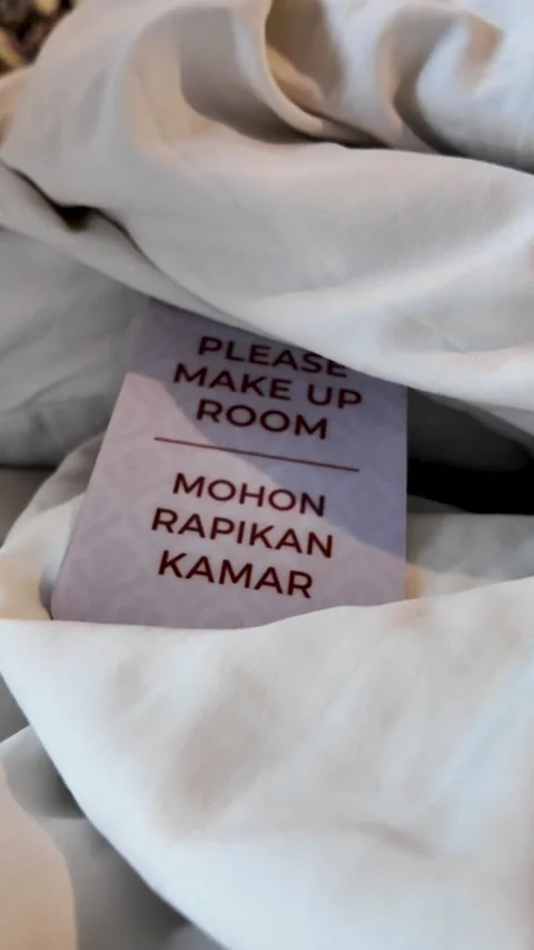 Please Make Up Room Sign Placed on Hotel Bed Sheets Stock Footage 345102496