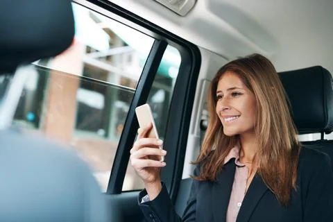 Please rate your chauffeur experience. a mature businesswoman using a mobile Stock Photos