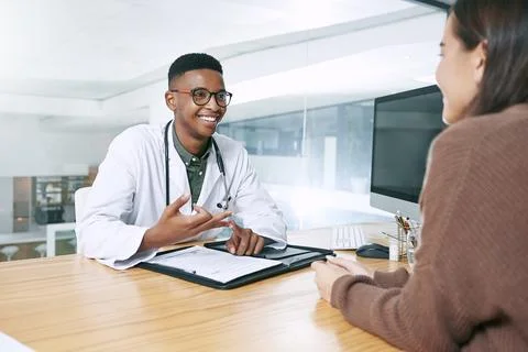 Please remember these two things. a handsome doctor sitting with his patient and Stock Photos