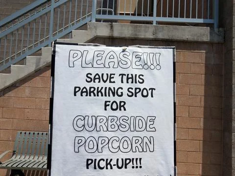 Please save the spot curbside popcorn pickup sign Stock Photos