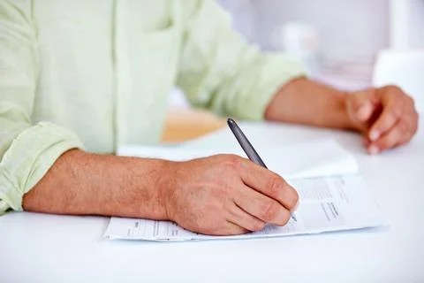 Please sign here. a businessman signing contracts. Stock Photos