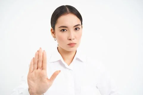 Please stop, enough. Serious asian female manager, businesswoman shows extended Stock Photos