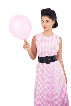 Pleased black hair model holding a pink balloon Stock Photos
