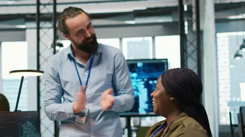 Pleased startup office manager applauding female programmer for optimizing code Stock Footage 313164823