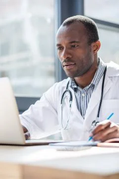 Pleased student completing task for examination Stock Photos