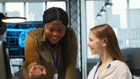 Pleased supervisor praises junior dev work, fostering positive office culture Stock Photos