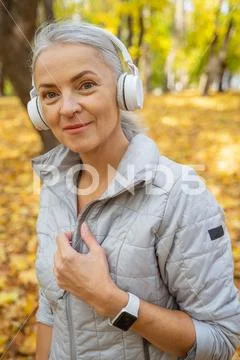 Pleased trendy lady wearing a fitness tracker Stock Photos