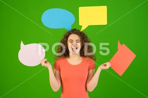 The pleased woman hold a dialog signs on the green background Stock Photos