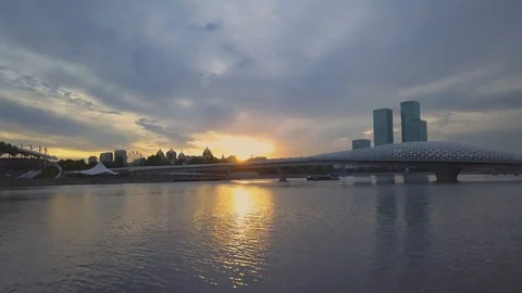 Pleasure boat sailing under the bridge in the background sunset, Astana Stock Footage 102414923