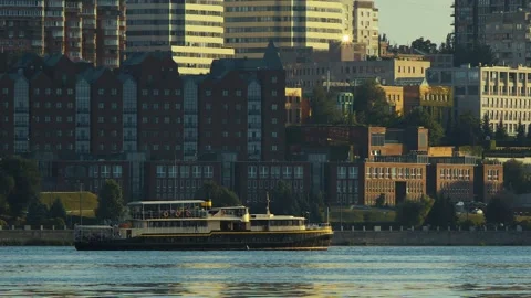 Pleasure boat sails against the backdrop of multi-storey buildings Stock Footage 166362657