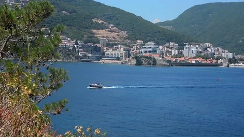 Pleasure boat sails to the island in the blue sea Stock Footage