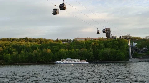 Pleasure craft sails under the cable car across the river Stock Footage 197373955