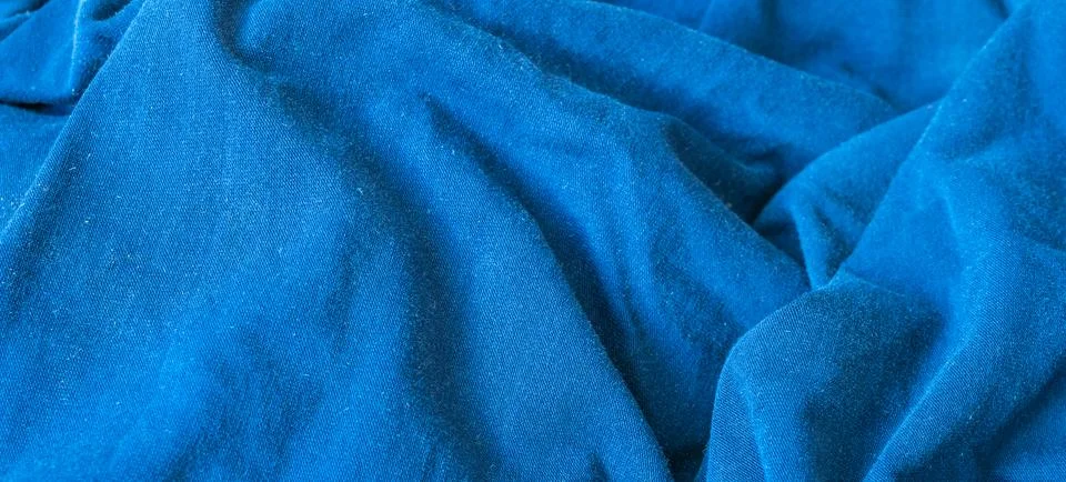 Pleated blue cotton material. texture or background Stock Photos