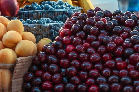 Plentiful display of fresh organic summer berries and fruits with sweet che.. Stock Photos