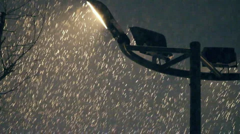 Plentiful snowfall in front of street light Stock Footage 1077873