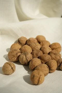 Plenty walnuts on a white tablecloth Stock-Fotos