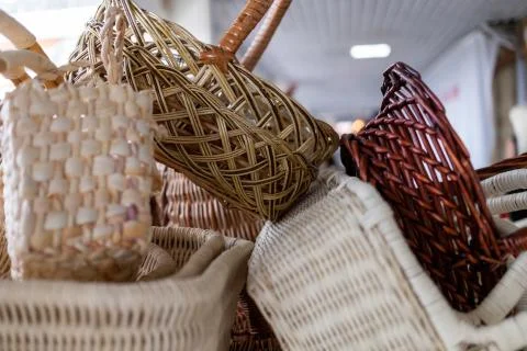 Plenty of wicker baskets of different colours on the counter 스톡 사진