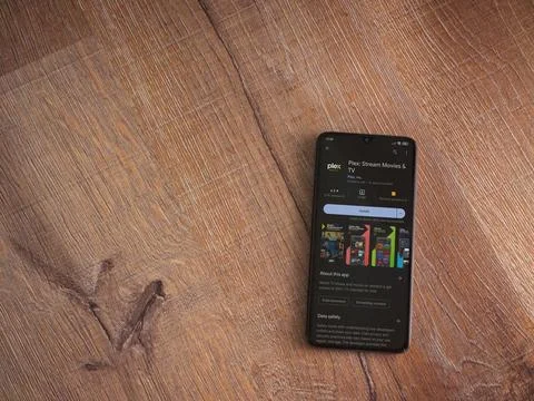 Plex app play store page on smartphone on wooden background Foto stock
