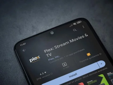 Plex app play store page on smartphone on a dark marble stone background Foto stock