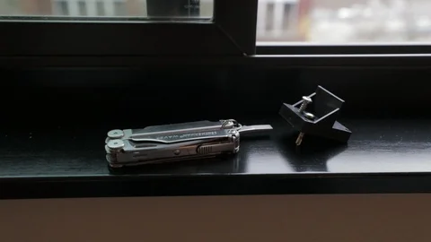 Plier multi function tool on window sill 스톡 동영상 121715110